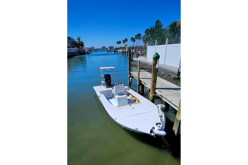 Slide: The Image of 2022 East Cape Vantage VHP boat docked in a serene waterfront setting. - 26