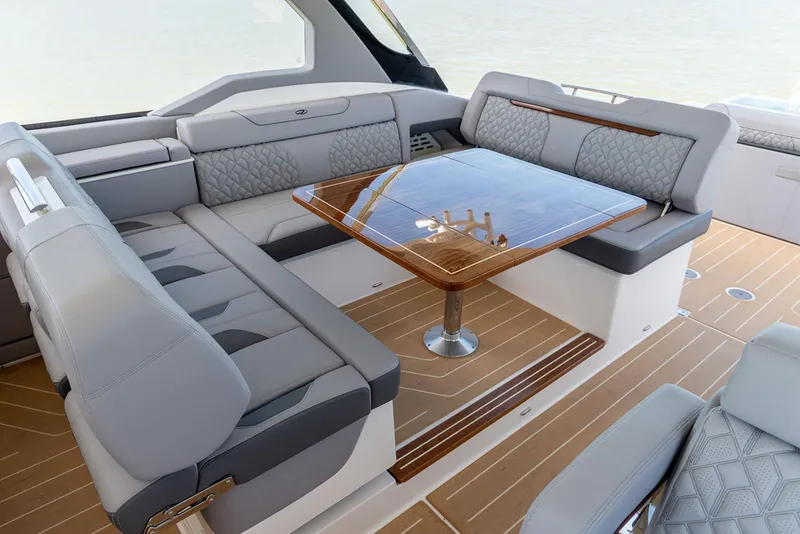 Slide: The Image of Manufacturer Provided Image: Luxurious seating area on 2026 Regal LX43 yacht with elegant wood table. - 10