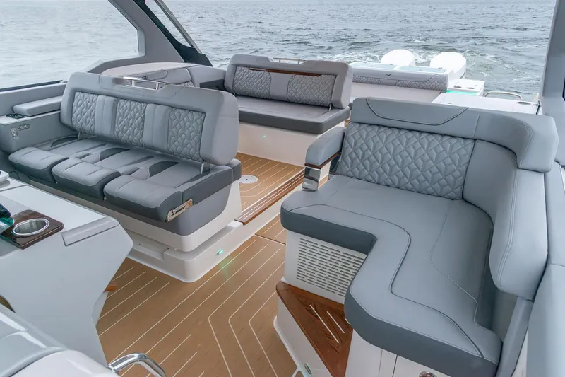 Slide: The Image of Manufacturer Provided Image: Luxurious interior of 2026 Regal LX43 boat with elegant seating and ocean view. - 11