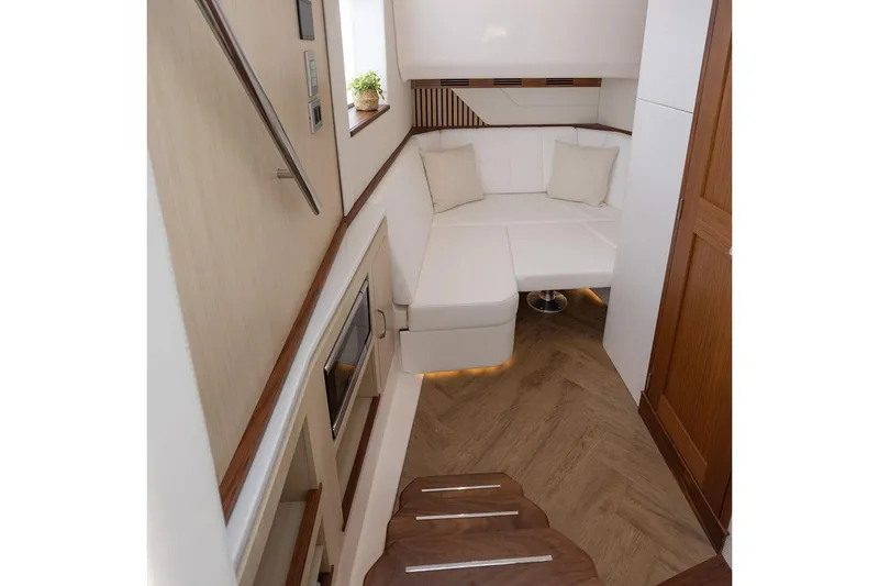 Slide: The Image of Manufacturer Provided Image: Luxurious interior of 2026 Regal LX43 yacht with modern seating and elegant wood finishes. - 17