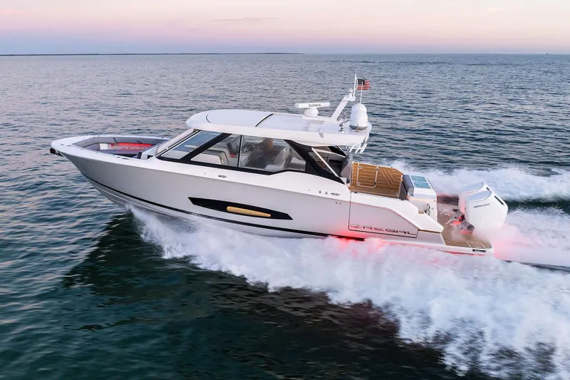 Slide: The Image of Manufacturer Provided Image: 2026 Regal LX43 yacht cruising on open water at sunset. - 1