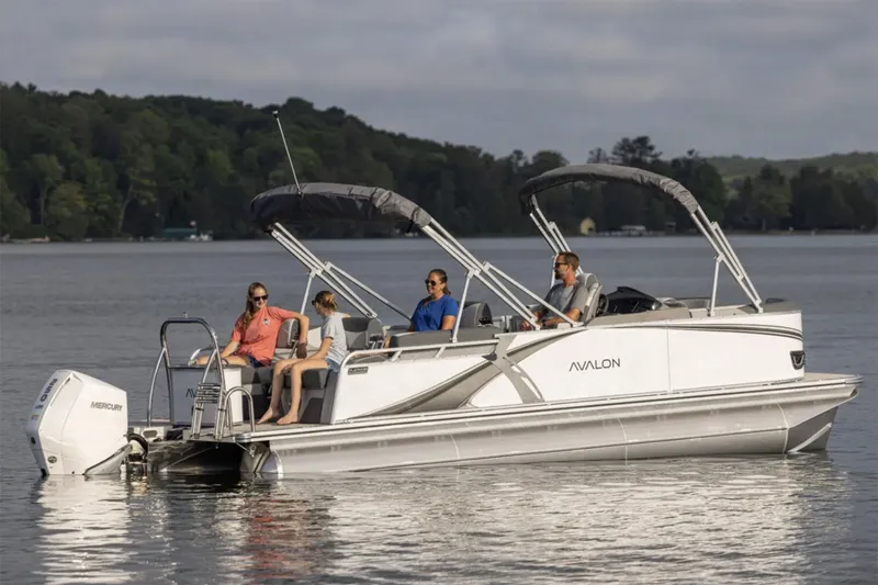 Slide: The Image of Manufacturer Provided Image: 2025 Avalon LSZ Quad Lounger Shift pontoon boat on a serene lake. - 5