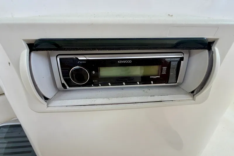 Slide: The Image of Kenwood stereo system on a 2002 Silverton 330 Sport Bridge boat dashboard. - 18
