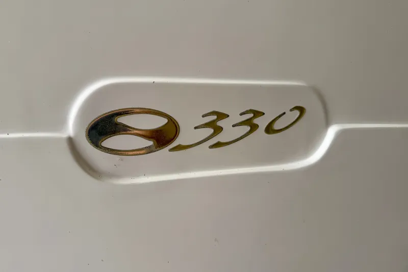 Slide: The Image of Silverton 330 Sport Bridge 2002 model emblem on white surface. - 39