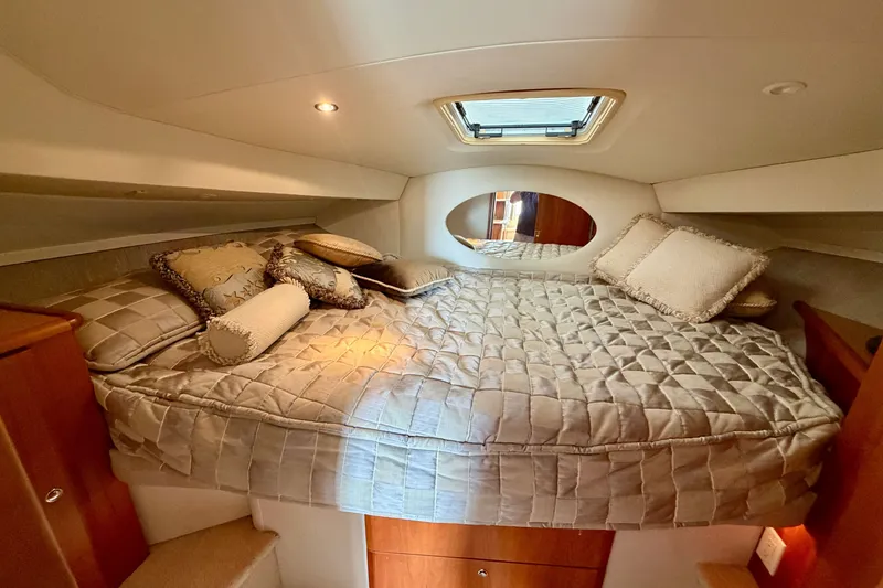 Slide: The Image of Luxurious cabin interior of 2002 Silverton 330 Sport Bridge with plush bedding and elegant decor. - 33