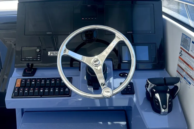 Slide: The Image of Helm of 2021 Pursuit OS 325 Offshore boat with steering wheel and control panel. - 9