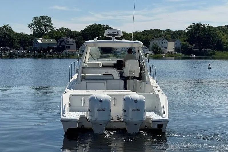 Slide: The Image of 2021 Pursuit OS 325 Offshore boat with twin Yamaha engines on a calm lake. - 2