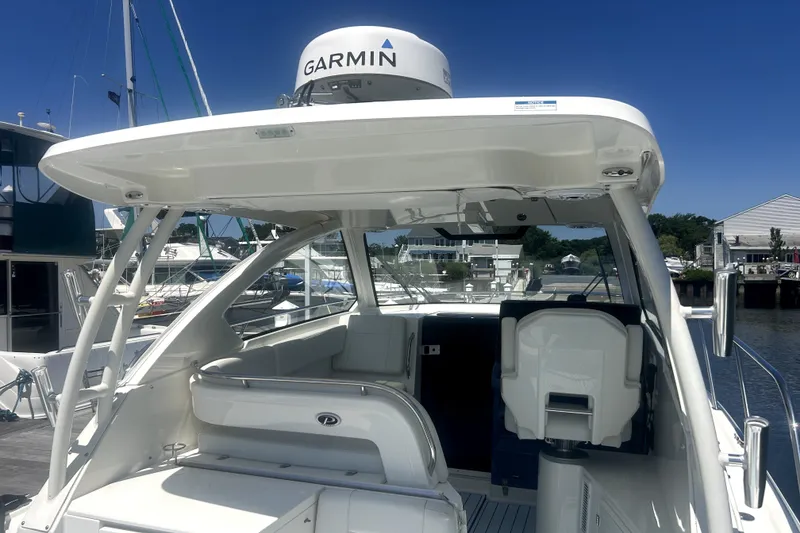 Slide: The Image of 2021 Pursuit OS 325 Offshore boat with Garmin radar, docked at a marina. - 13