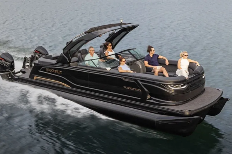 The Image of 2027 Godfrey Sanpan 2500 MTF iMPACT pontoon boat cruising on water with passengers. - 1