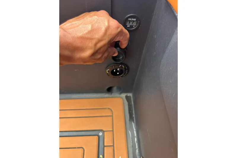 Slide: The Image of Hand operating controls on 2026 Patrol 760 RIB boat dashboard. - 27