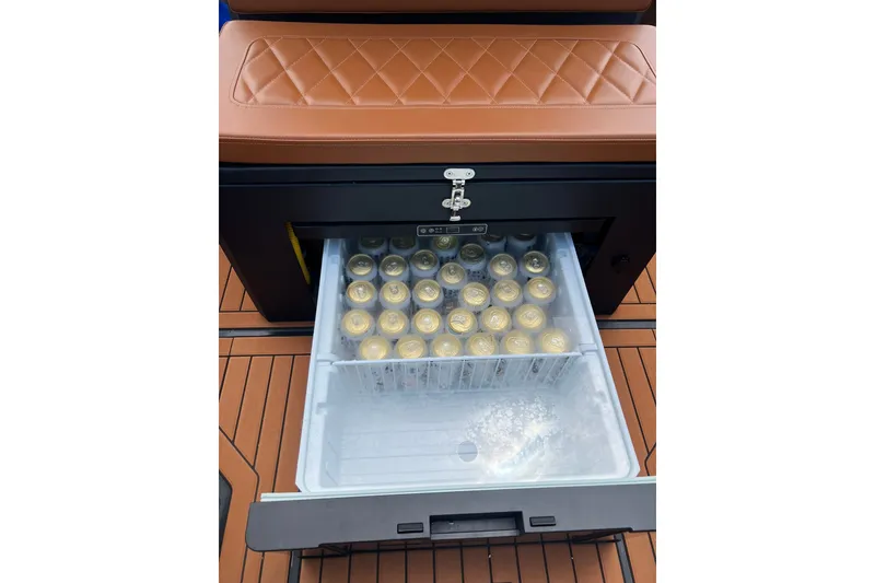 Slide: The Image of 2026 Patrol 760 RIB boat with onboard cooler filled with canned beverages. - 16