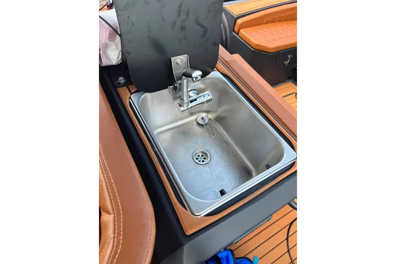 Slide: The Image of Stainless steel sink on 2026 Patrol 760 RIB boat with brown leather seating. - 17