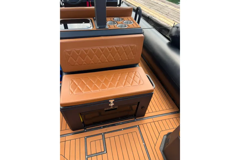Slide: The Image of 2026 Patrol 760 RIB boat interior with tan diamond-stitched seating and cup holders. - 15