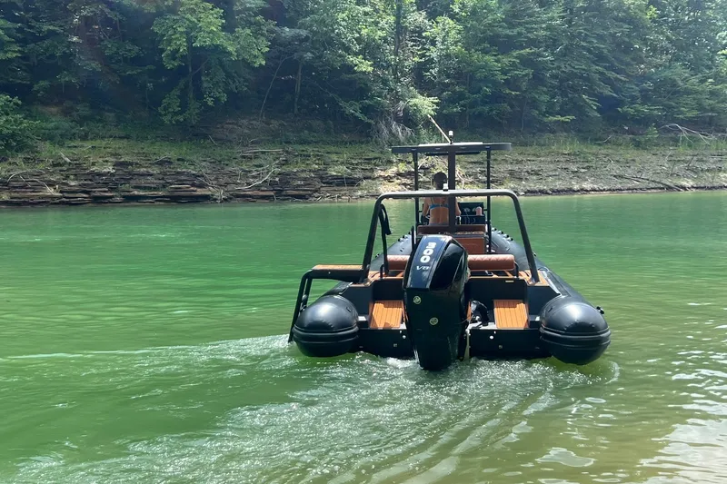 Slide: The Image of 2026 Patrol 760 RIB navigating a serene, green river with lush forest backdrop. - 4