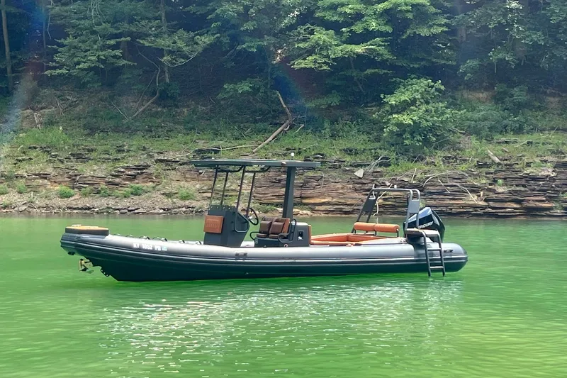 Slide: The Image of 2026 Patrol 760 RIB boat on green water, surrounded by lush trees. - 3