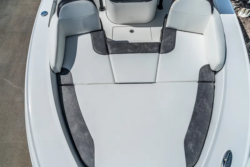 Slide: The Image of The image shows the bow deck of a 2019 Crevalle 24 Bay boat with cushioned seating. - 20