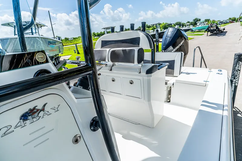 Slide: The Image of The image shows a 2019 Crevalle 24 Bay boat with a clean white deck and black seating. - 16