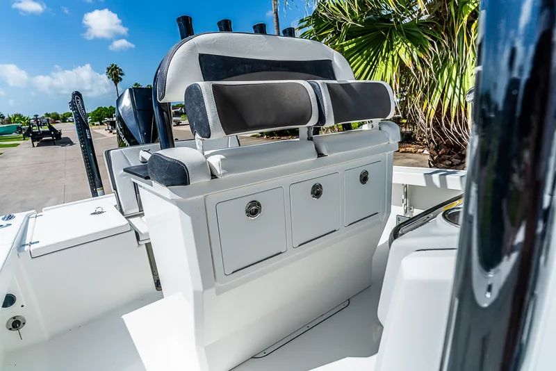 Slide: The Image of The image shows the cockpit of a 2019 Crevalle 24 Bay boat with seating and storage. - 23
