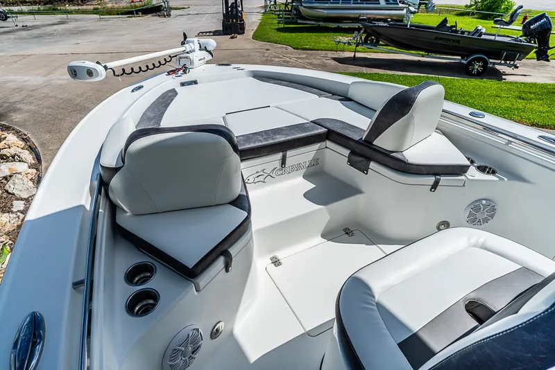 Slide: The Image of The image shows the cockpit of a 2019 Crevalle 24 Bay boat with cushioned seating. - 19