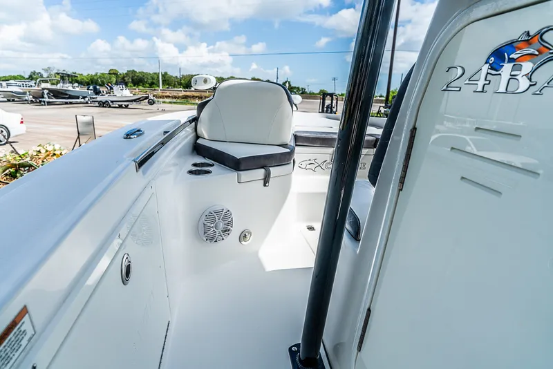 Slide: The Image of The image shows the cockpit of a 2019 Crevalle 24 Bay boat with white seating and speakers. - 18