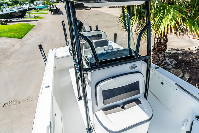 Slide: The Image of The image shows a 2019 Crevalle 24 Bay boat with a clean, modern cockpit and seating area. - 22