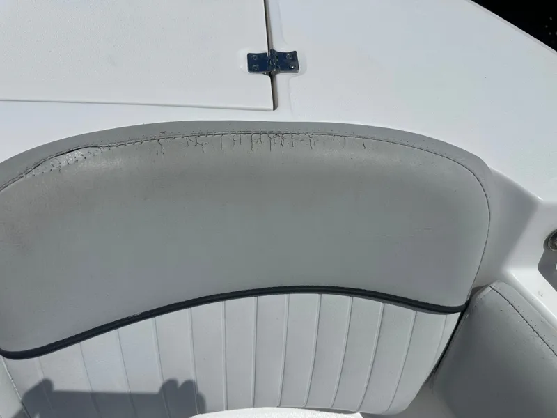 Slide: The Image of Close-up of a white boat seat with gray upholstery and visible stitching. - 15