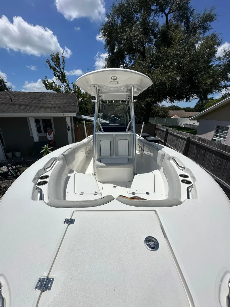 Slide: The Image of A 2020 Sea Fox 228 Commander with T-top, spacious deck, and seating, parked outdoors. - 13