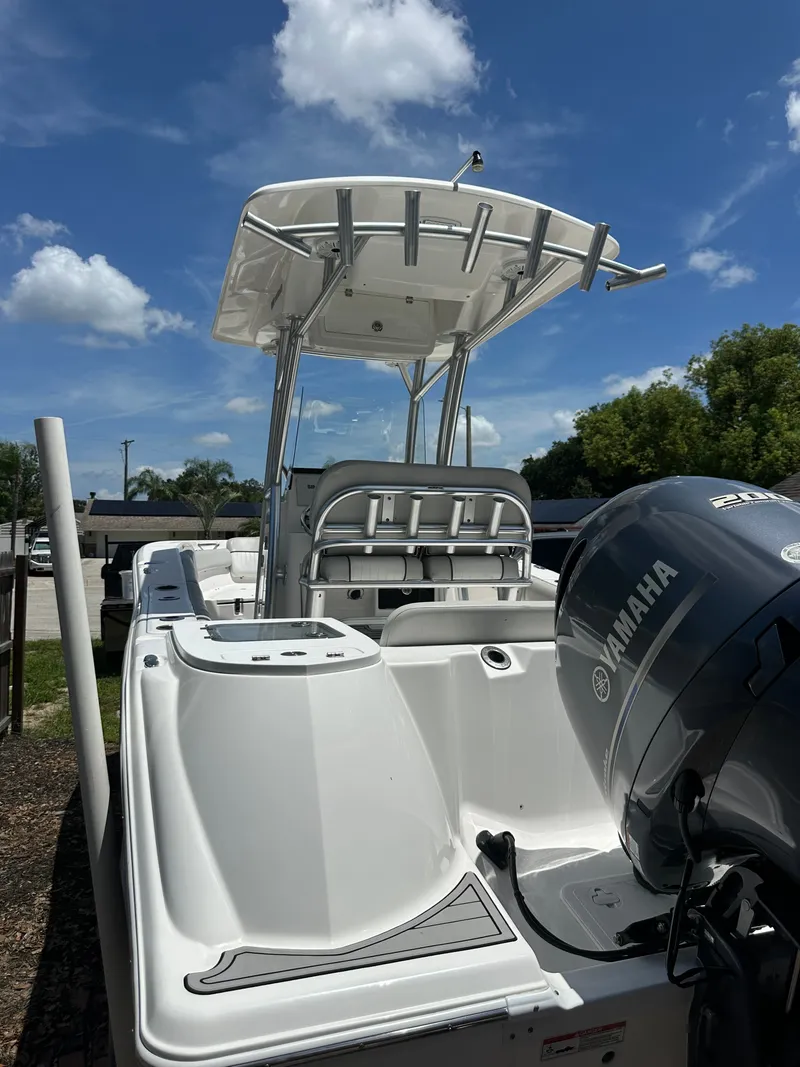 Slide: The Image of A white Sea Fox 228 Commander boat with a Yamaha outboard motor, parked under a blue sky. - 44