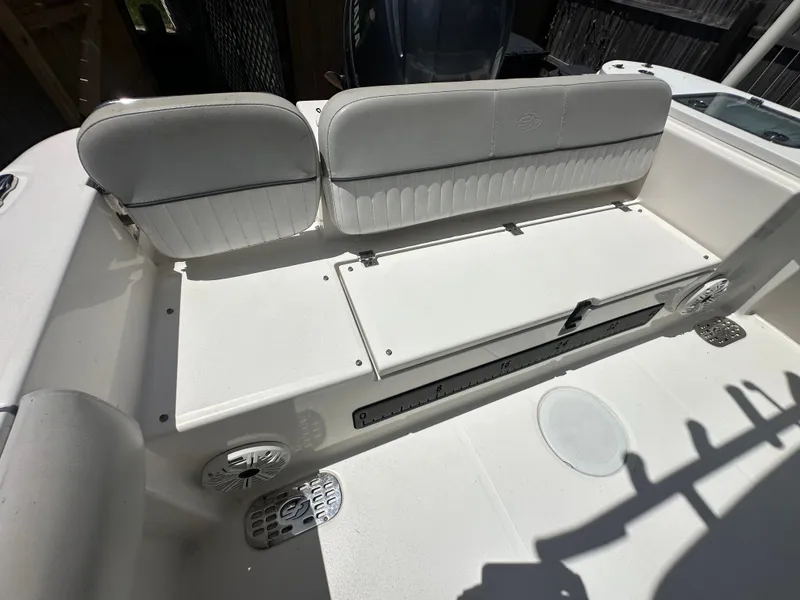 Slide: The Image of The 2020 Sea Fox 228 Commander features a white bench seat with storage underneath. - 42