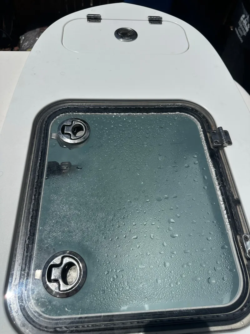 Slide: The Image of A boat hatch with water droplets on the surface, surrounded by a white frame. - 34