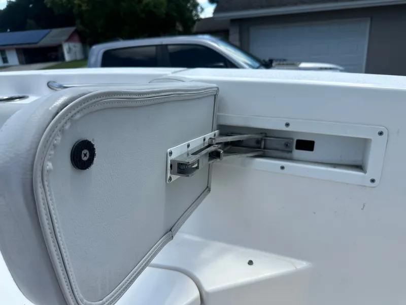 Slide: The Image of Close-up of a white boat seat with a foldable backrest and metal fittings. - 25