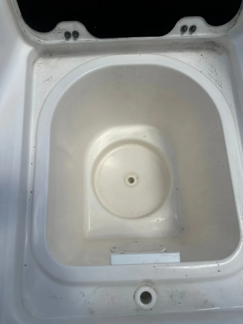 Slide: The Image of A white, oval compartment in the boat, possibly a storage or cooler area. - 22