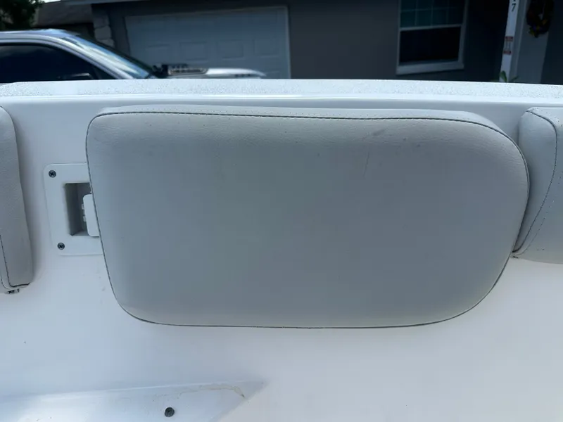 Slide: The Image of The image shows a gray cushion on the back of a boat, likely a backrest. - 23