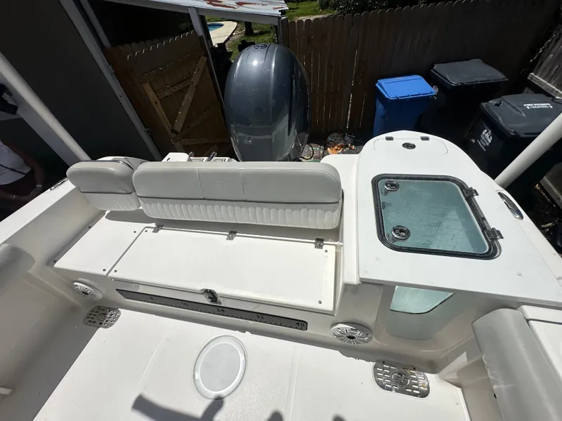 Slide: The Image of The image shows the stern of a Sea Fox 228 Commander boat with an outboard motor and seating. - 32