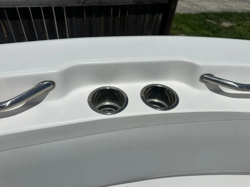 Slide: The Image of The image shows stainless steel cup holders and grab handles on a boat. - 16
