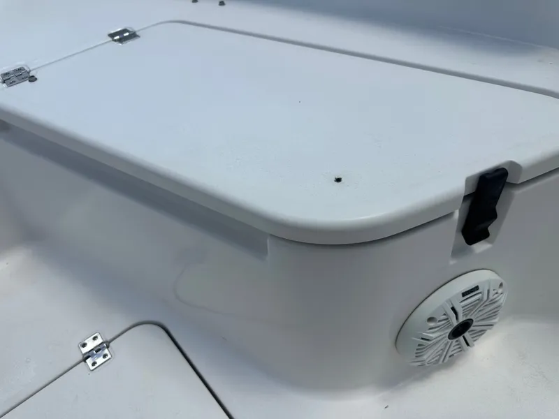 Slide: The Image of The image shows a white storage compartment lid on a boat with a speaker below it. - 18