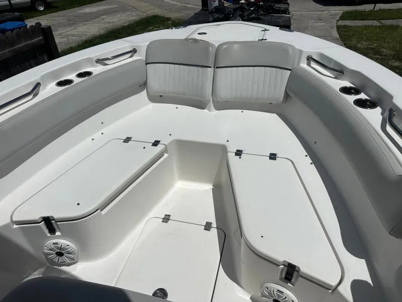 Slide: The Image of The image shows the bow area of a 2020 Sea Fox 228 Commander boat with white seating and storage. - 14