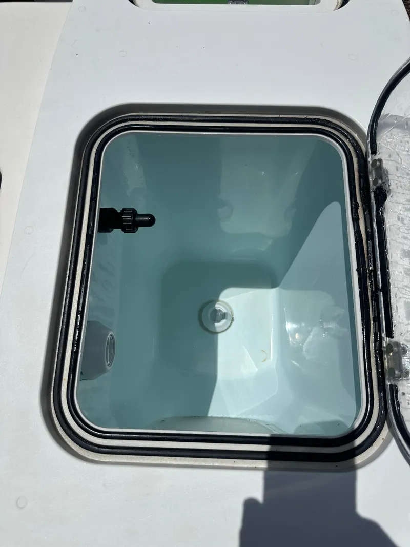Slide: The Image of An open compartment on a boat reveals an empty, rectangular storage space with a transparent lid. - 35