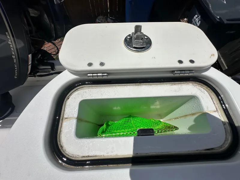 Slide: The Image of A livewell on a Sea Fox 228 Commander boat with a green net inside. - 36