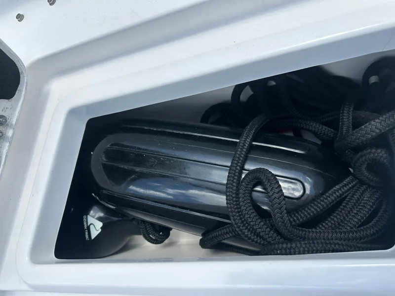 Slide: The Image of A black fender and rope in a boat's storage compartment. - 20