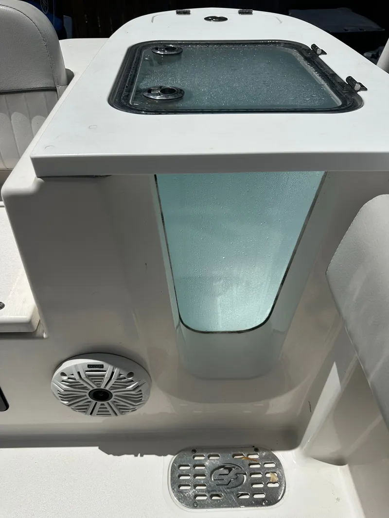 Slide: The Image of The image shows part of the interior of a Sea Fox 228 Commander boat with a built-in speaker and glass window. - 33