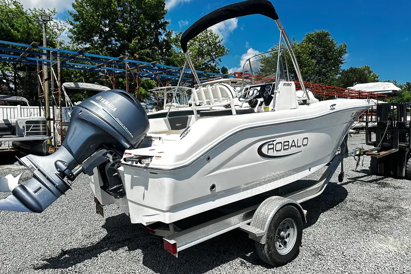 Slide: The Image of 2024 Robalo R180 Center Console boat with Yamaha engine on trailer. - 1