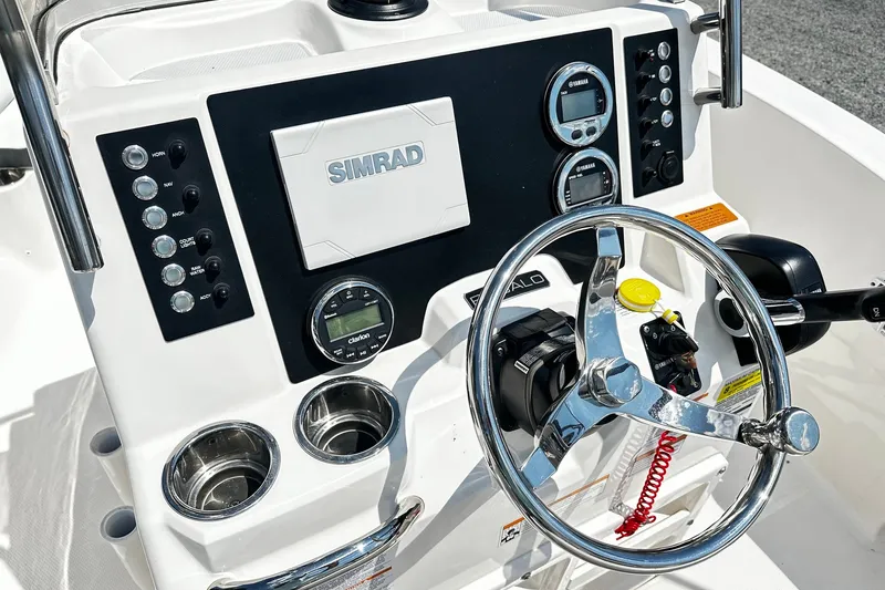Slide: The Image of 2024 Robalo R180 Center Console dashboard with steering wheel and Simrad display. - 5