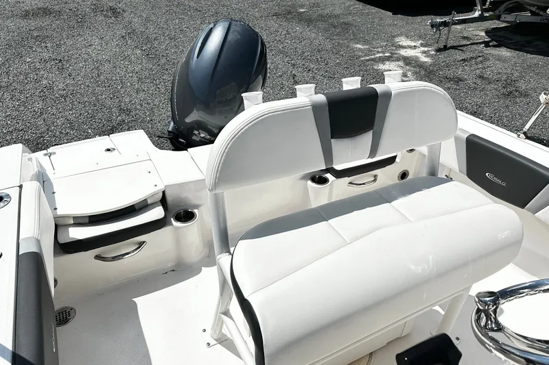 Slide: The Image of 2024 Robalo R180 Center Console boat interior with seating and motor, showcasing sleek design. - 6