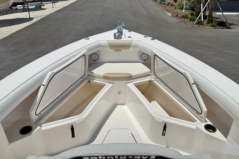 Slide: The Image of 2014 Everglades 255 Center Console boat with open storage compartments and seating area. - 28