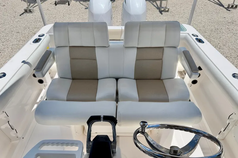 Slide: The Image of 2014 Everglades 255 Center Console boat with dual cushioned seats and steering wheel. - 13