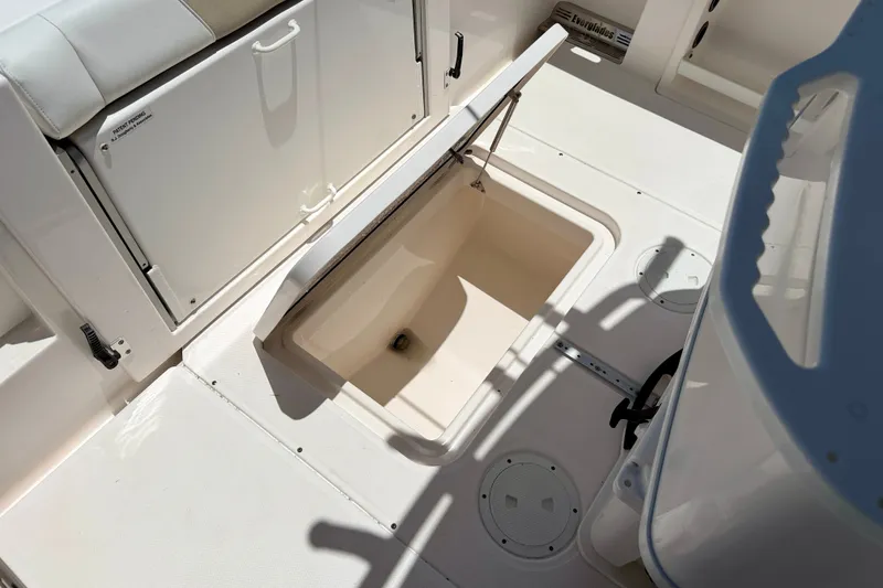 Slide: The Image of 2014 Everglades 255 Center Console boat interior with open storage compartment. - 30