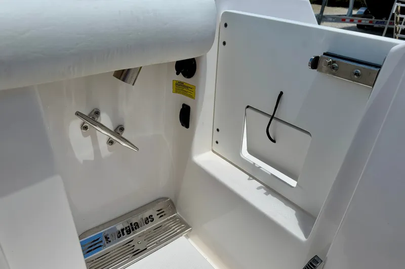 Slide: The Image of 2014 Everglades 255 Center Console boat interior detail with cleat and storage compartment. - 31