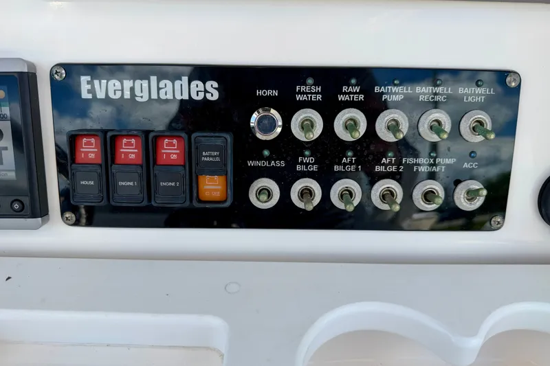 Slide: The Image of Control panel of a 2014 Everglades 255 Center Console boat with various switches. - 21