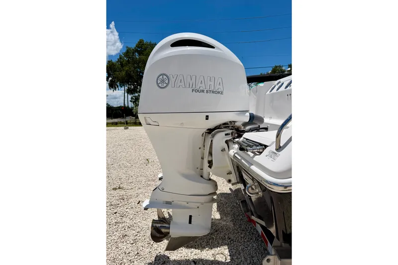 Slide: The Image of 2014 Everglades 255 Center Console with Yamaha four-stroke outboard motor in sunny outdoor setting. - 39